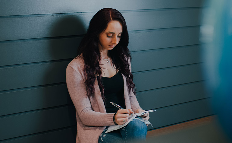 A patient writing in a journal